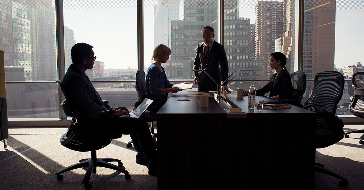 A meeting with four people in a large room