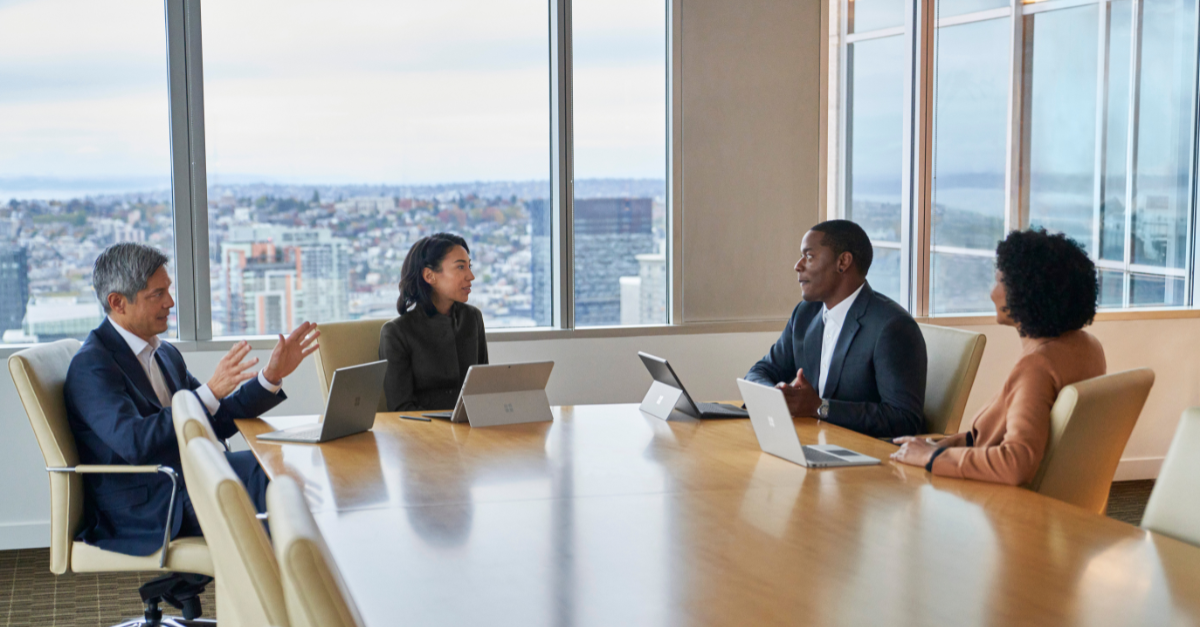 A group of businesspeople meeting at a large conference table.