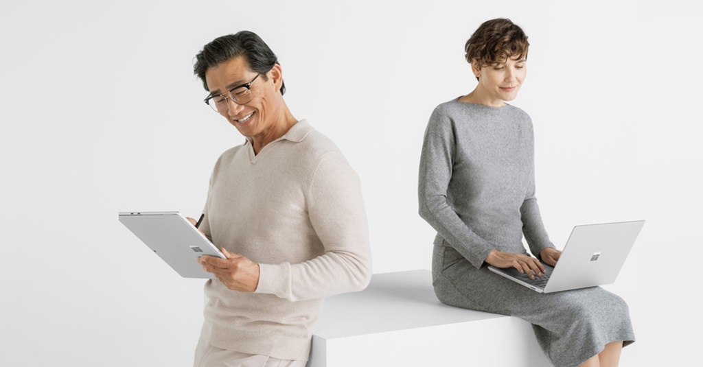 Two people using new Surface devices.