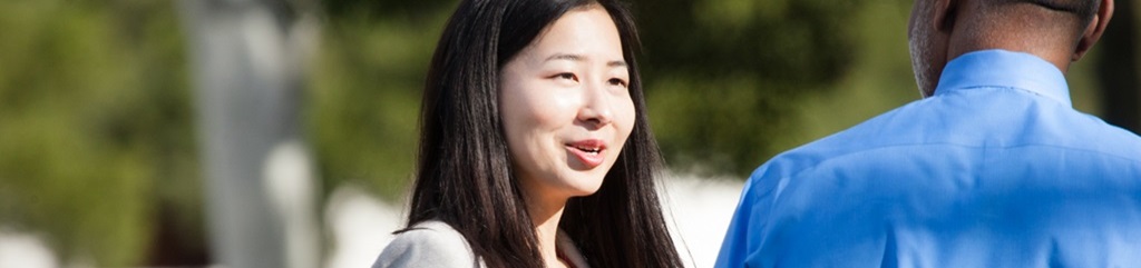 Two businesspeople outside having a discussion.