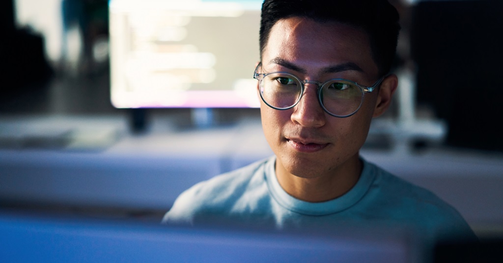 Young developer in darkened office.