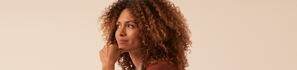 A portrait of a young businesswoman in a thoughtful pose.