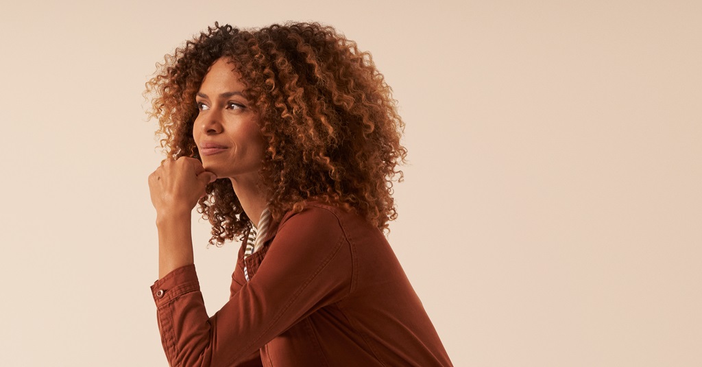 A portrait of a young businesswoman in a thoughtful pose.