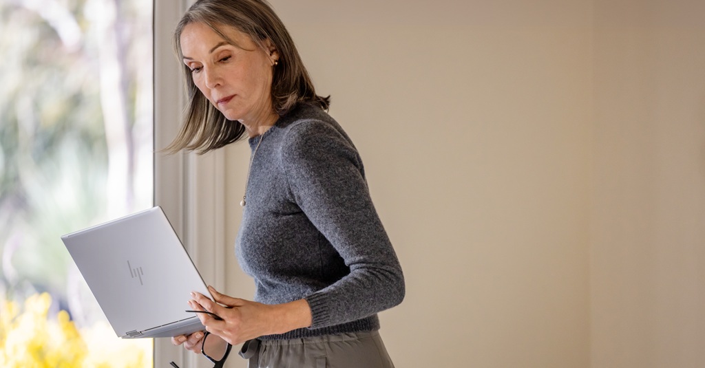 A woman looking at her laptop.